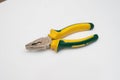 a yellow pair of pliers is placed on a white base Royalty Free Stock Photo