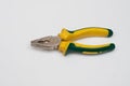 a yellow pair of pliers is placed on a white base Royalty Free Stock Photo