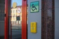 Yellow panel with a call button for help for people with disabilities on a wheelchair Royalty Free Stock Photo