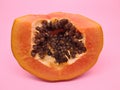 Yellow papaya fruit with a pink background