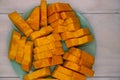 Yellow papaya slice in green plate on white wooden table. Orange papaya fruit cut top view photo Royalty Free Stock Photo