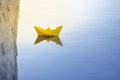 Yellow paper boat floating in the water Royalty Free Stock Photo