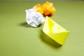 yellow paper boats and reams of paper