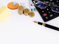 Yellow paper and funtain pen and coins and calculator and eyeglasses Royalty Free Stock Photo