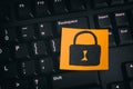 Yellow paper note with closed padlock on a black keyboard Royalty Free Stock Photo