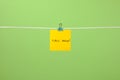Yellow paper note on clothesline with text Call Now! Royalty Free Stock Photo