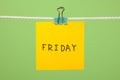 Yellow paper note on clothesline with text Friday Royalty Free Stock Photo