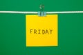 Yellow paper note on clothesline with text Friday Royalty Free Stock Photo