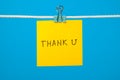 Yellow paper note on clothesline with text Thank U Royalty Free Stock Photo