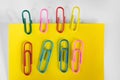 Yellow paper note with colorful paper clips. Royalty Free Stock Photo