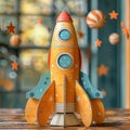 A yellow paper rocket is sitting on a table with a blue background. Royalty Free Stock Photo