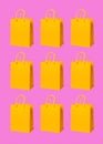 Yellow paper shopping bags pattern on pink background. Shopping sale delivery concept. Packaging gift