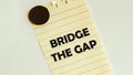 Yellow paper with text Bridge The Gap on the white fridge Royalty Free Stock Photo