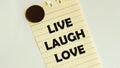 Yellow paper with text Live laugh love on the white fridge Royalty Free Stock Photo