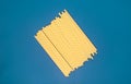 Yellow paper tubes for drinks on a blue background. Abstraction Royalty Free Stock Photo
