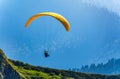 Yellow paraglider over the Green Mountain slope