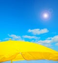 Yellow parasol on the beach under a clear sky