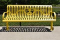 Yellow park bench with paw print cutout Royalty Free Stock Photo