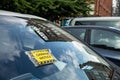 Yellow Parking Charge Notice on a windshield of a car which has not paid for the parking in Glasgow Royalty Free Stock Photo