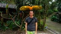 Yellow Parrot / Macaw bird on Men`s head in Macaw Mountain Bird Park, Honduras.