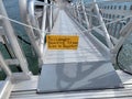 yellow passenger boarding sign on gangplank to boat