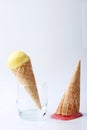 Yellow passion fruit and red strawberry ice cream cones dropped Royalty Free Stock Photo