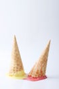 Yellow passion fruit and red strawberry ice cream cones Royalty Free Stock Photo