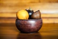 Yellow passion fruits, mangosteen and salak in wooden bowl. Mix of exotic fresh fruits from Bali, Indonesia