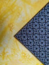 yellow patterned walls with batik patterned wall accessories
