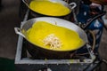 The yellow patties with the breasts are stuffed and fried on a pan to make a snack at Ban Chak Ngaew Chinese Community Market