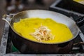 The yellow patties with the breasts are stuffed and fried on a pan to make a snack at Ban Chak Ngaew Chinese Community Market