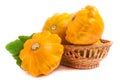 Yellow pattypan squash with leaf in a wicker basket isolated on white background Royalty Free Stock Photo
