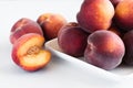 Yellow peaches on white plate, on white table Royalty Free Stock Photo