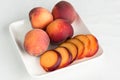Yellow peaches on white square plate Royalty Free Stock Photo