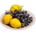 Yellow pear and grapes on plate Royalty Free Stock Photo