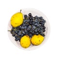 Yellow pear and grapes on plate Royalty Free Stock Photo