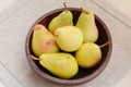 Yellow pears in old wooden bowl Royalty Free Stock Photo