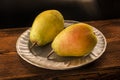 Yellow pears on a silver plate