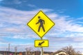 Yellow Pedestrian Crossing and Arrow sign with cloudy blue sky in the background Royalty Free Stock Photo