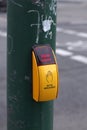 yellow pedestrian crossing button on green pole with icon of hand and red text above: Signal kommt, which means Signal Royalty Free Stock Photo