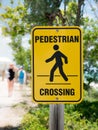 A yellow pedestrian crossing sign on nature backgroud Royalty Free Stock Photo