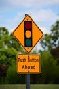 A Yellow Pedestrian Street Crossing with Stop Light Sign