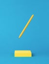 A yellow pen flying over a stack of yellow paper on a blue background. Minimal concept of office supplies Royalty Free Stock Photo