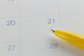 yellow pen points to the number 21 on calendar background.