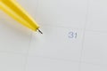 yellow pen points to the number 31 on calendar background.