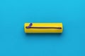 Yellow pencil case for pencils and pens on a blue background. Flat lay Royalty Free Stock Photo