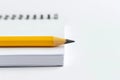 Yellow pencil on open spiral notebook with blank pages. Education, business, accounting, planning background