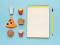 Yellow pencil and a set of fast food on a blue background Royalty Free Stock Photo