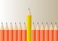 Yellow pencil standing out from orange pencils, leadership,difference and stand out from the crowd business concept