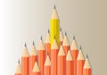 Yellow pencil standing out from orange pencils, leadership,difference and stand out from the crowd business concept Royalty Free Stock Photo